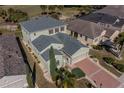 Aerial view of a well-maintained home with a manicured lawn at 445 Noble Faire Dr, Sun City Center, FL 33573