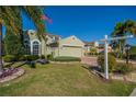 Beautifully landscaped home with a well-maintained lawn and garden at 445 Noble Faire Dr, Sun City Center, FL 33573