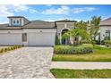 Charming two-story home with a well-manicured front yard, stone driveway and entryway at 4551 Barletta Ct, Wesley Chapel, FL 33543