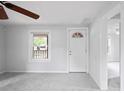 Bright living room with fresh paint, new carpeting, a ceiling fan, and ample natural light at 5042 8Th St, Zephyrhills, FL 33542