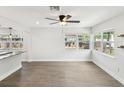 Spacious living area with hardwood floors, large windows, and open access to the stylish kitchen at 6436 2Nd S Ave, St Petersburg, FL 33707