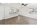 Bright and airy living room with modern flooring, large windows, and kitchen pass-through at 6436 2Nd S Ave, St Petersburg, FL 33707