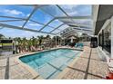 Enjoy the Florida lifestyle with this screened-in pool and patio with outdoor bar and plenty of space for relaxing at 743 Kingston Ct, Apollo Beach, FL 33572