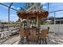 This fun tiki bar is perfect for poolside entertaining and gatherings in a tropical backyard oasis at 743 Kingston Ct, Apollo Beach, FL 33572
