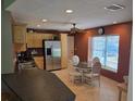 Eat-in kitchen with stainless steel appliances, light wood cabinetry, and a breakfast nook at 827 Creekside Ln, Palm Harbor, FL 34684