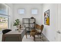 Stylish home office with a sleek desk, modern shelving, and a comfortable armchair, perfect for productivity at 9474 Shorebird Ct, Parrish, FL 34219