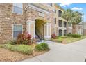 Charming entrance with stone accents and lush landscaping at 10203 Courtney Palms Blvd # 301, Tampa, FL 33619