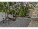 Inviting backyard patio with seating, fire pit, and well-maintained landscaping, perfect for outdoor relaxation at 1041 Forest Grove Blvd, Palm Harbor, FL 34683