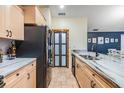 Well-lit kitchen boasts granite countertops, custom cabinets, stainless appliances, and convenient access to dining at 1041 Forest Grove Blvd, Palm Harbor, FL 34683