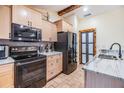 Modern kitchen featuring stainless steel appliances, light wood cabinets, and granite countertops at 1041 Forest Grove Blvd, Palm Harbor, FL 34683