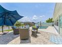 Inviting backyard patio with outdoor seating, a swimming pool, and waterfront views at 10710 Donbrese Ave, Tampa, FL 33615