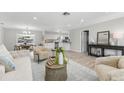 Bright and airy living room with modern decor and seamless flow into the dining area at 10710 Donbrese Ave, Tampa, FL 33615