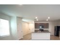 Open-concept kitchen featuring modern appliances, granite countertops, and ample storage space at 10928 Carlton Fields Dr, Riverview, FL 33579