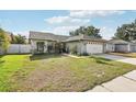 Charming one-story home with a well-manicured lawn and a two-car garage at 11849 Cedarfield Dr, Riverview, FL 33579