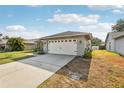 Two-car garage with brick veneer, a new roof, and a wide concrete driveway at 11849 Cedarfield Dr, Riverview, FL 33579
