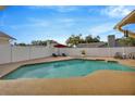 Inviting in-ground pool surrounded by a white fence and ample lounge space at 1410 Monte Lake Dr, Valrico, FL 33596