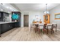 Inviting dining area with sleek black cabinets, a modern dining table, and wood-look tile flooring at 199 Dali Blvd # 403, St Petersburg, FL 33701