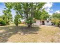A view of the home's partially shaded, grassy backyard at 2003 Waikiki Way, Tampa, FL 33619