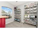 Well-organized storage room with metal shelving units filled with clear plastic storage containers and a window at 2823 Banyan Hill Ln, Land O Lakes, FL 34639