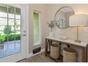 A sunlit entryway offers tile floors, console table, decorative accents and a view to the outdoors at 4139 Rocky Shores Dr, Tampa, FL 33634