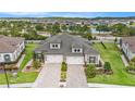 An aerial view of a lovely townhouse showing the garages, brick driveway, and landscaping at 4329 Barletta Ct, Wesley Chapel, FL 33543