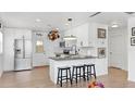 Bright kitchen features stainless steel appliances, granite countertops, modern lighting, and breakfast bar with seating at 4735 W Oklahoma Ave, Tampa, FL 33616