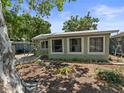 A single-story home featuring multiple windows for ample natural light and a well-maintained yard at 544 80Th N Ave, St Petersburg, FL 33702