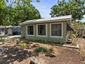 A single-story home featuring multiple windows for ample natural light and lush landscaping at 544 80Th N Ave, St Petersburg, FL 33702