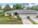 Attractive single-story home featuring a two-car garage and landscaped front yard at 5456 Fairway Bend Dr, Sarasota, FL 34243