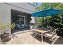 Inviting back patio with comfortable seating, mature trees, and a large umbrella for outdoor relaxation at 5914 Goldenbark Pl, Lithia, FL 33547