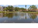 View of a serene pond with a fountain, enhancing the beauty of the community at 5920 80Th N St # 103, St Petersburg, FL 33709