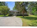 A charming single-story home with a covered porch and a well-maintained front yard at 6501 Barcellona Rd, Land O Lakes, FL 34637