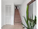 Light and bright entryway features tiled flooring, stairs and closet space at 745 Pinellas Bayway S # 206, St Petersburg, FL 33715