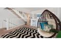 Stylish living area with open staircase, bar seating and comfortable hanging chair at 745 Pinellas Bayway S # 206, St Petersburg, FL 33715