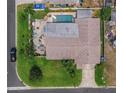 Birds-eye view of house with a swimming pool, patio, and a well-maintained lawn at 7851 120Th St, Seminole, FL 33772