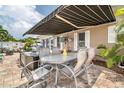 Charming outdoor patio featuring a dining table, chairs, and a retractable awning at 7851 120Th St, Seminole, FL 33772
