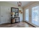 Elegant foyer with decorative glass double doors, wood-look tile flooring, and stylish decor at 817 Eagle Ln, Apollo Beach, FL 33572