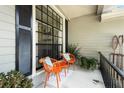 Inviting front porch featuring cozy seating, decorative plants, and charming exterior details at 8401 Ashford Pl, Trinity, FL 34655