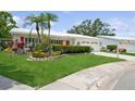 Inviting single-Gathering home with a well-kept lawn, decorative plants, and a clean, bright exterior at 9018 39Th N Ln # 5, Pinellas Park, FL 33782