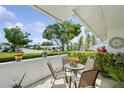 Cozy patio seating area, perfect for relaxing, featuring outdoor furniture and lush greenery at 9018 39Th N Ln # 5, Pinellas Park, FL 33782