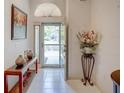 Bright foyer with tiled floors, transom window, and stylish decor at 934 Lucas Ln, Oldsmar, FL 34677