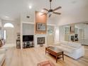 Spacious living room with a fireplace, vaulted ceilings, and mirrored wall at 934 Lucas Ln, Oldsmar, FL 34677