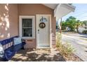 Inviting front porch with a cozy bench, decorative wreath, and a welcoming entrance at 1174 8Th N St, St Petersburg, FL 33701