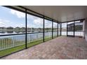 Screened-in patio overlooking a beautiful lake view, perfect for relaxing and entertaining outdoors at 12352 Crestridge Loop, New Port Richey, FL 34655