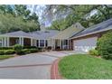 Lovely traditional home with brick accents, circular driveway, well maintained lawn, and two-car garage at 124 Barrington Dr, Brandon, FL 33511