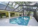 Inviting screened-in pool area with lounging space and a summer kitchen perfect for outdoor entertaining at 124 Barrington Dr, Brandon, FL 33511