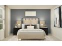 Comfortable main bedroom featuring a king-size bed, elegant bedside tables, and modern decor at 15038 Zircon Red Dr, Wimauma, FL 33598