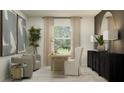 Bright home office with modern furnishings, decorative plants, and a large window overlooking greenery at 15038 Zircon Red Dr, Wimauma, FL 33598