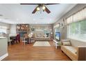 Cozy living room with a brick fireplace, hardwood floors, and a comfortable seating area with ample light at 1722 48Th N Ave, St Petersburg, FL 33714