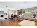 Open-concept living area featuring hardwood floors, a brick fireplace, and seamless flow to the kitchen at 1722 48Th N Ave, St Petersburg, FL 33714